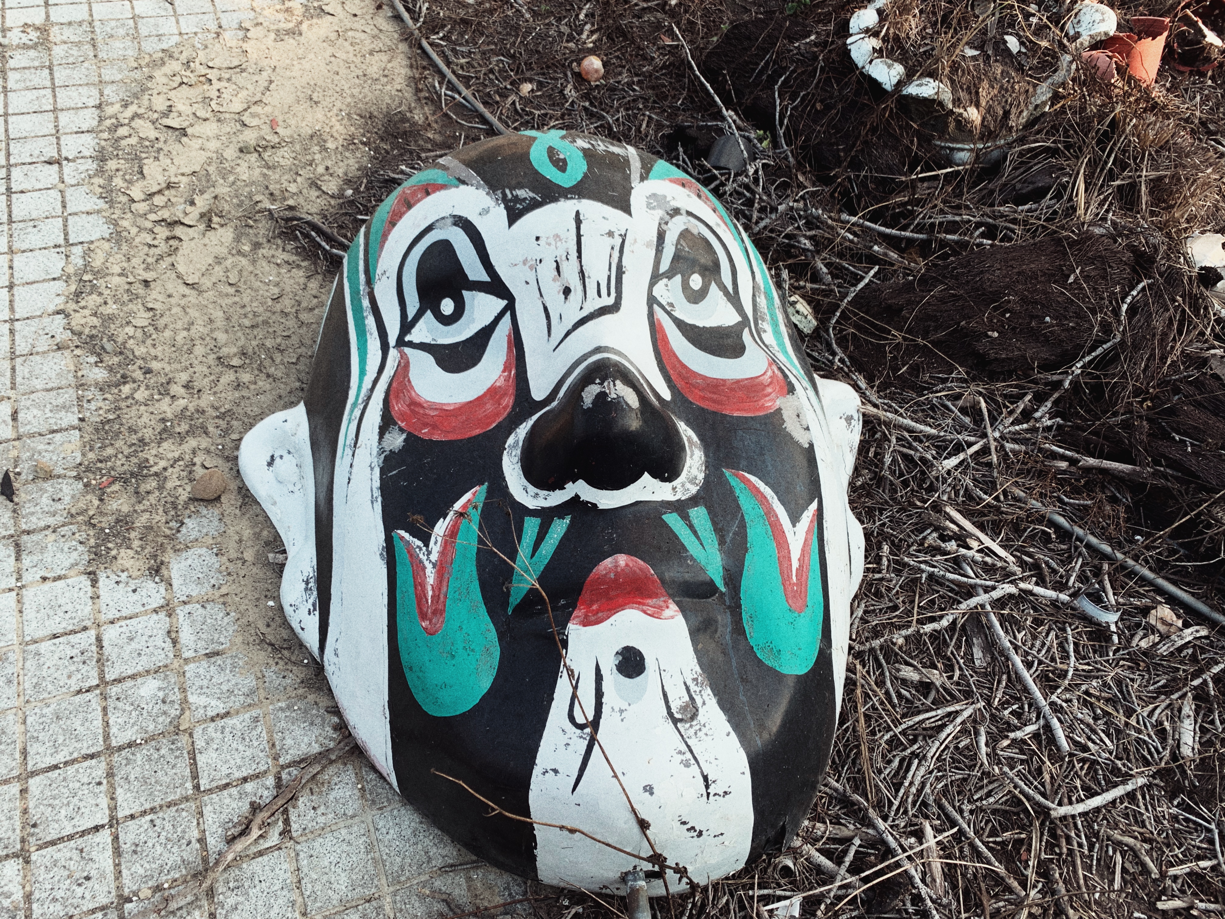 A large colorful mask on the gorund