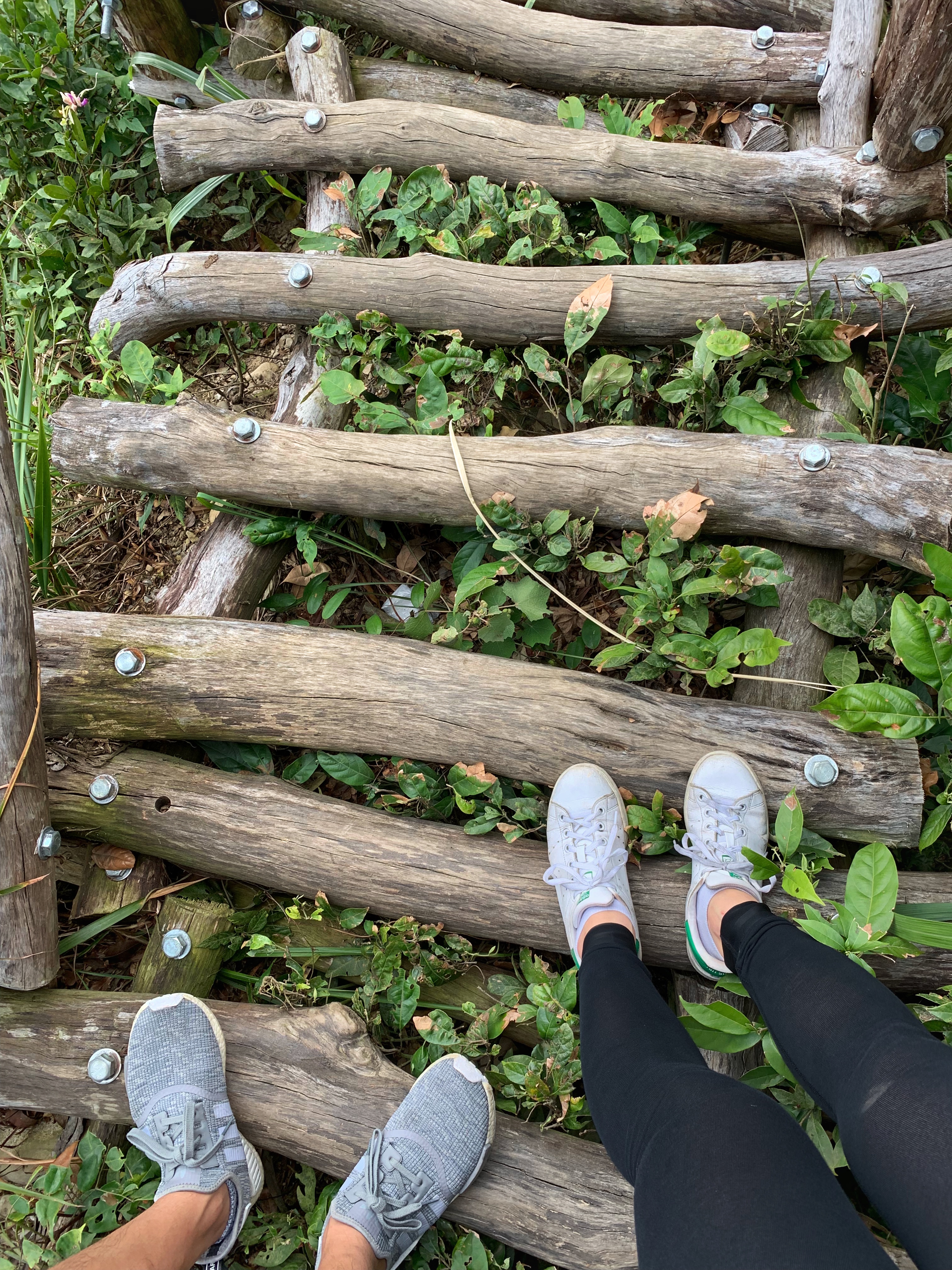 Dacheng Trail, two people standing on logs