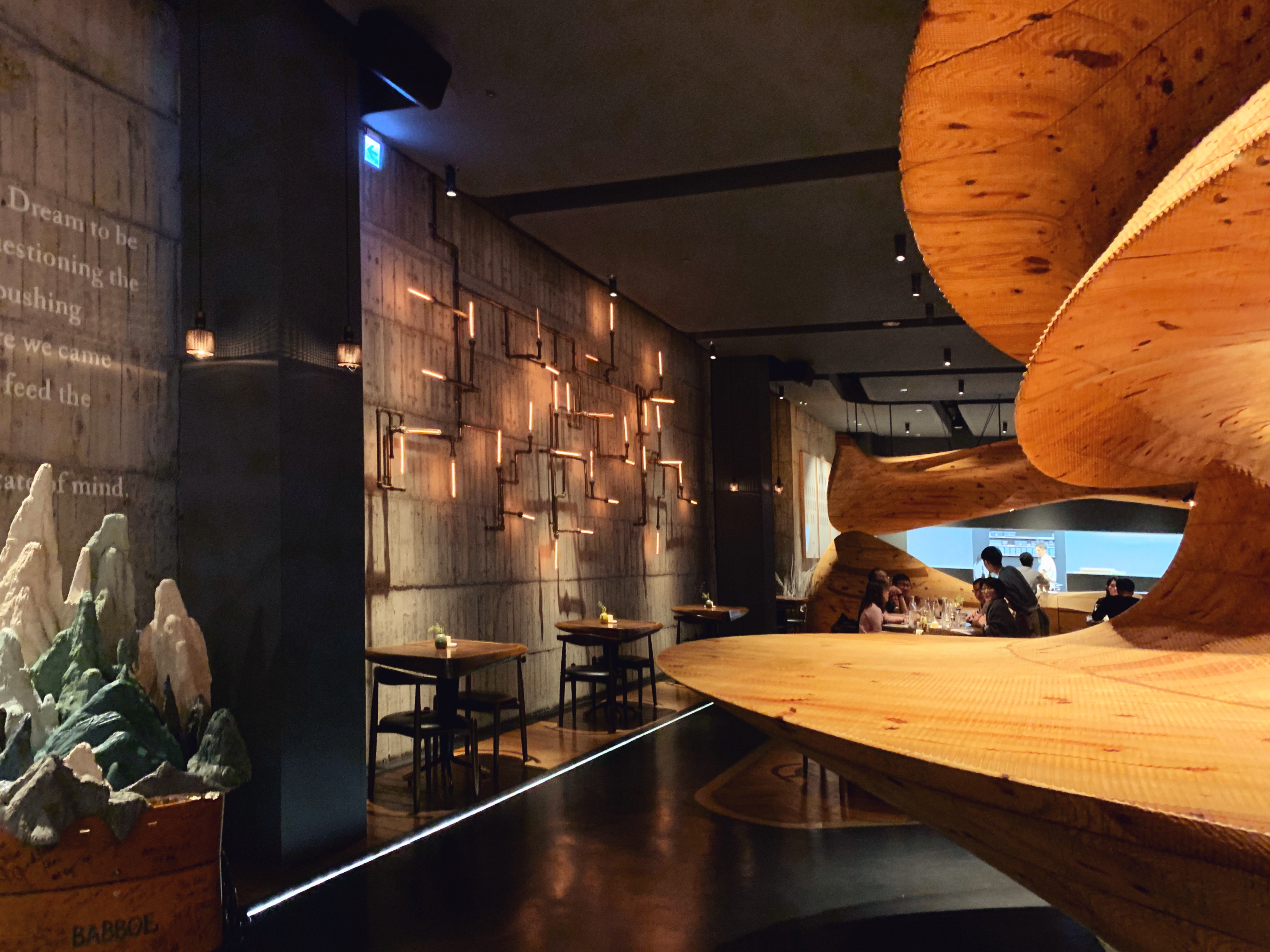 Rustic lights and pipes on a wall at Raw Taipei