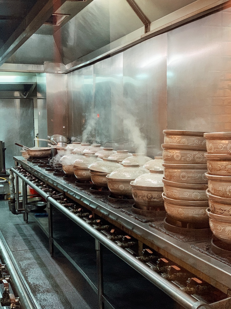 Lines of clay pots steaming away with the creamy chicken broth