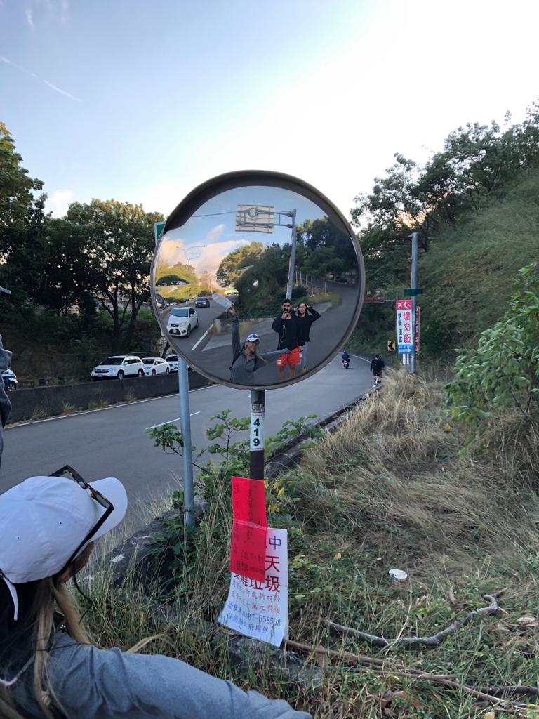 Hikers celebrating through a mirror.