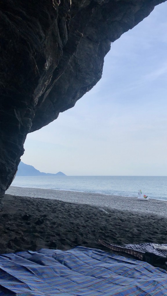 Tarps and a floating unicorn under a cave